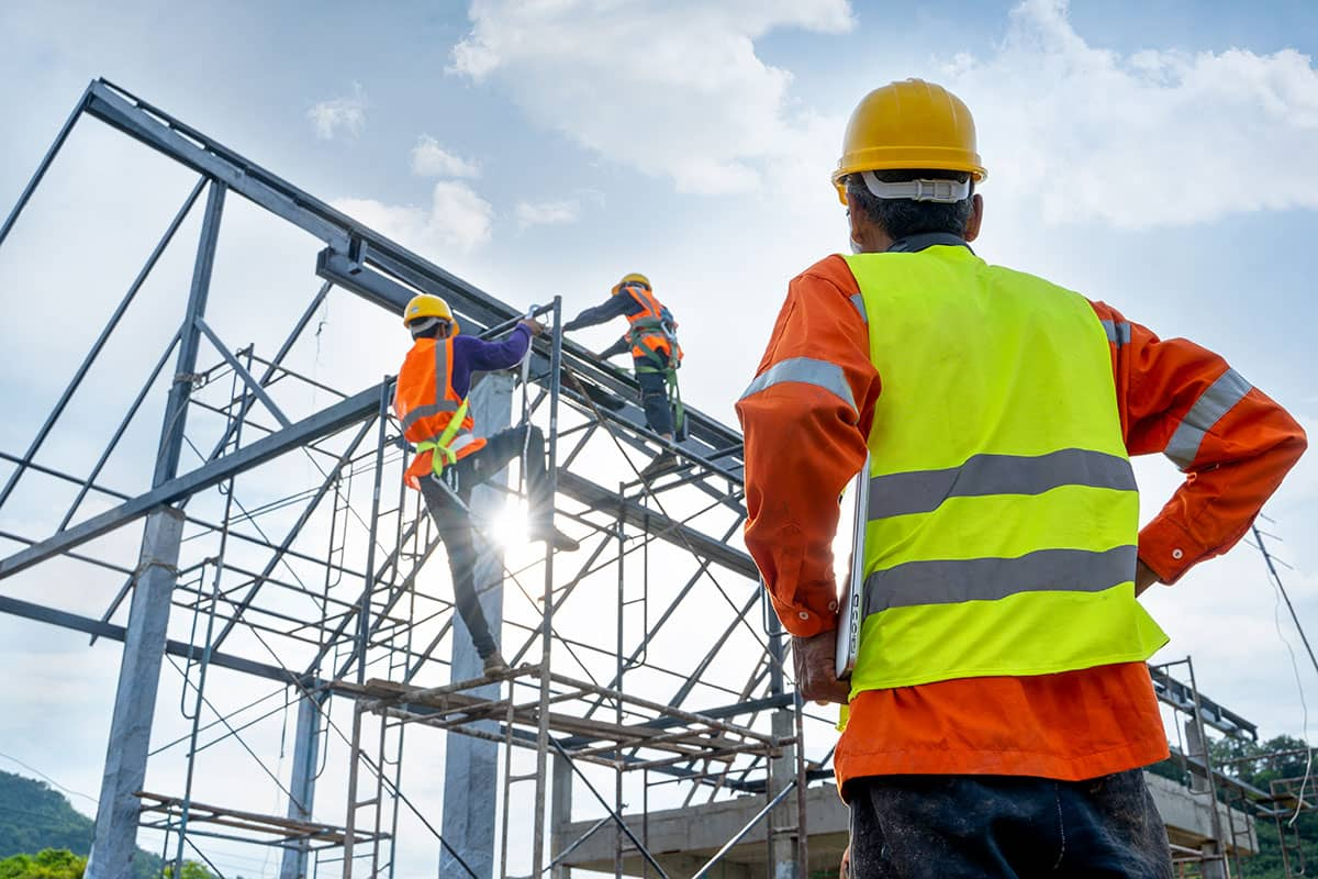 Construction crew erecting a steel structural frame on site