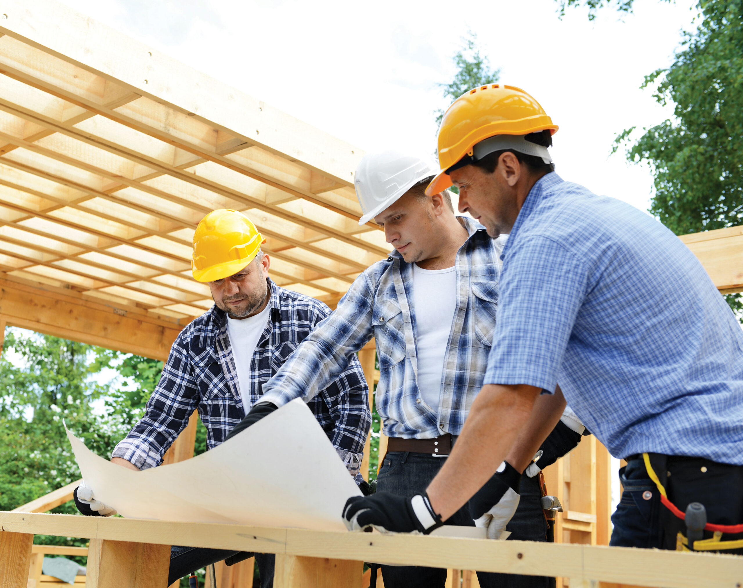 Maximum Constructions crew reviewing blueprints on site